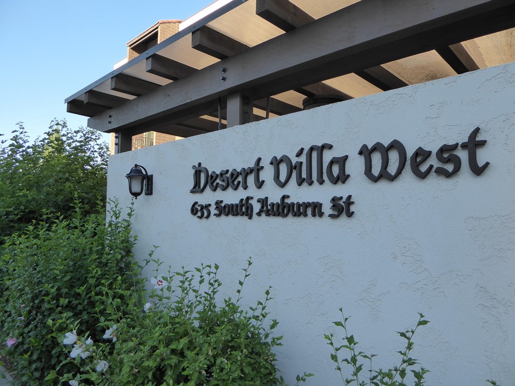 a white building with a sign that reads desert villa west 65 south tacoma