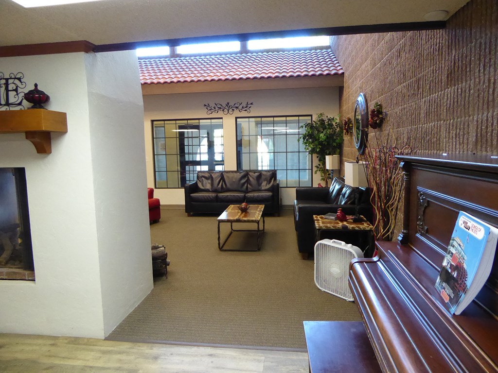a living room with couches and tables and a fireplace