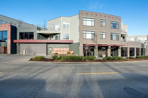 an empty street in front of a building with a sign that reads public point