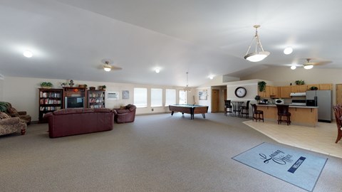 A spacious living room with a couch, a television, and a dining area.