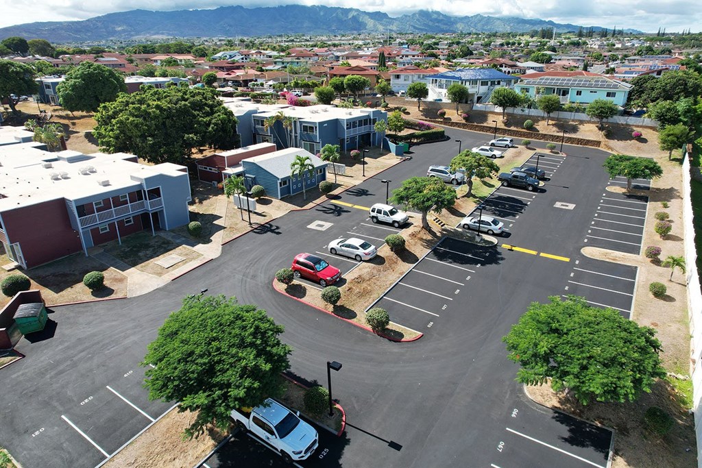 A parking lot with cars and a view of the mountains in the distance.