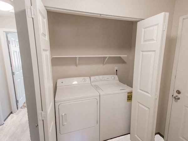 an empty laundry room with a washer and dryer