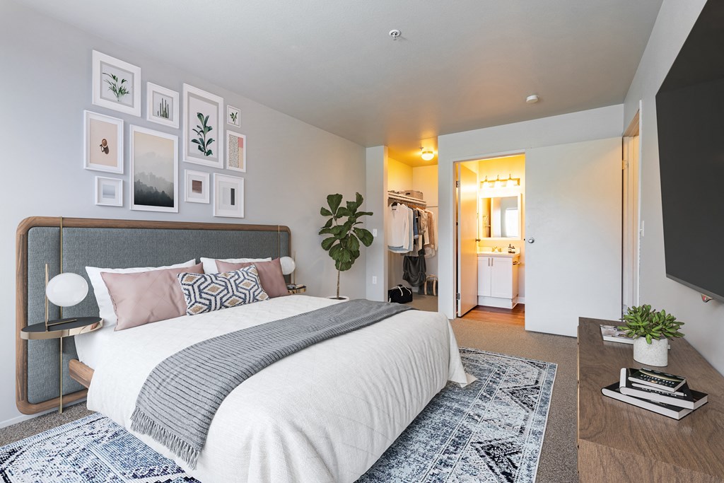 a bedroom with a bed and a tv