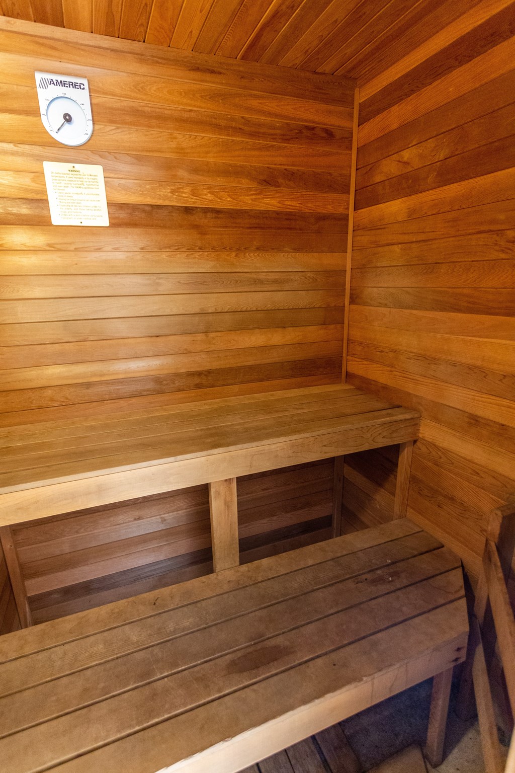 a sauna with wooden walls and a wooden bench