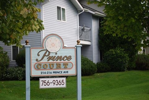 a sign that says prince court in front of a house