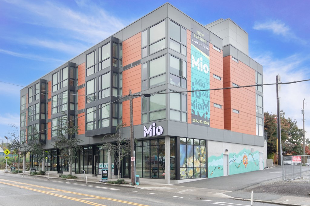 a large building with a sign on it on the side of a street