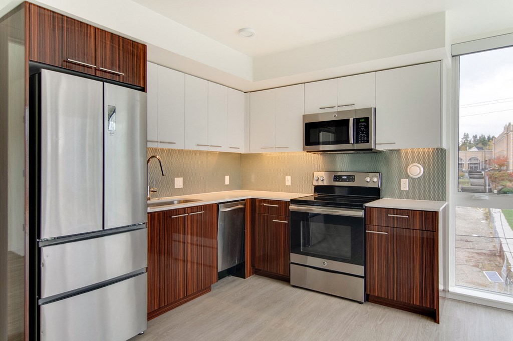 a kitchen with stainless steel appliances and white cabinets
