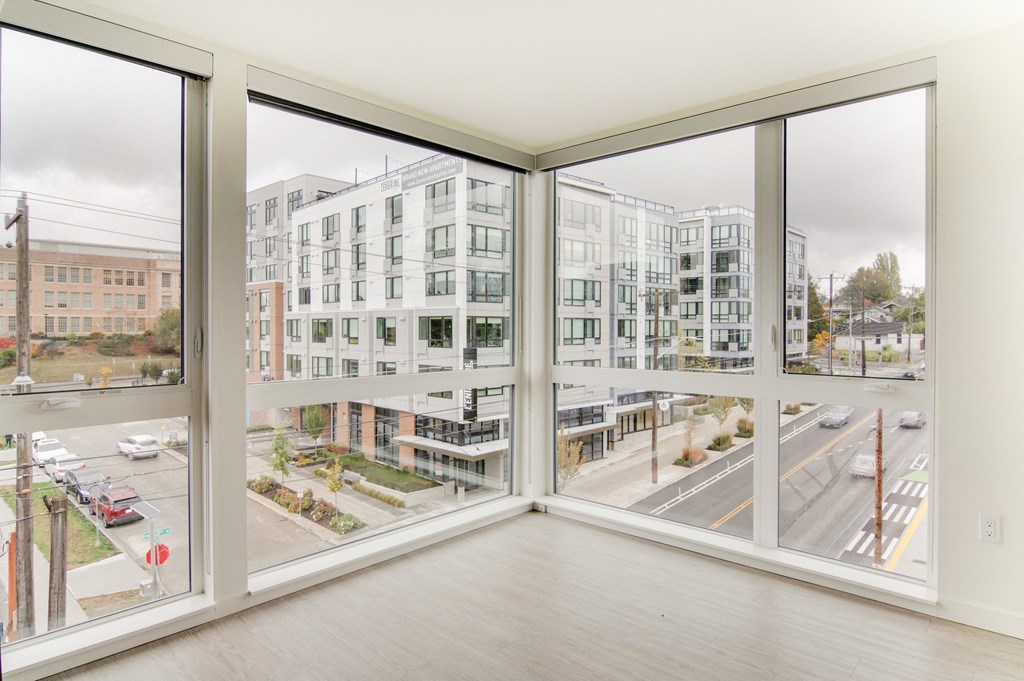 a living room with large windows and a city view