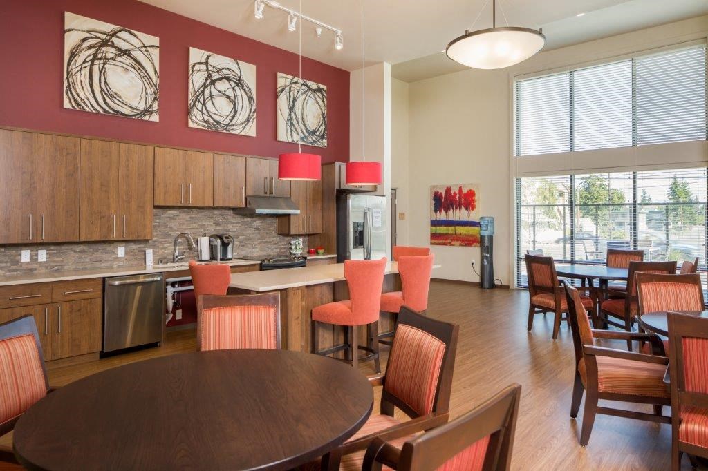 a kitchen and dining room with a table and chairs
