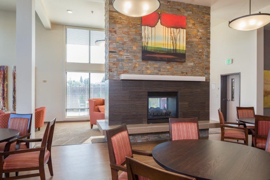 a dining room with a fireplace and a table and chairs