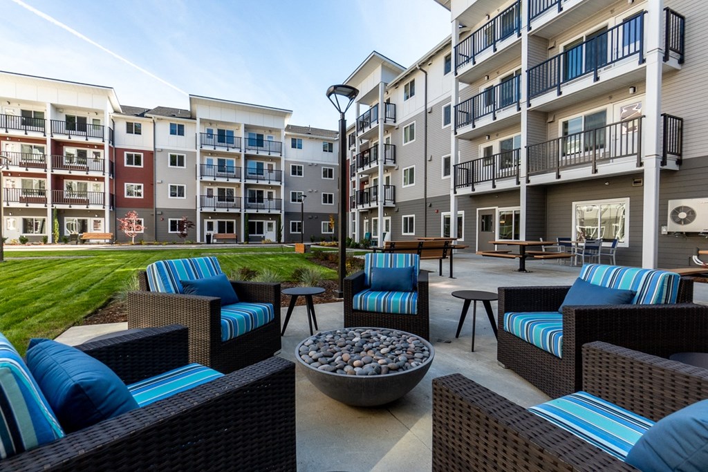 an outdoor lounge area with furniture at the grove apartments