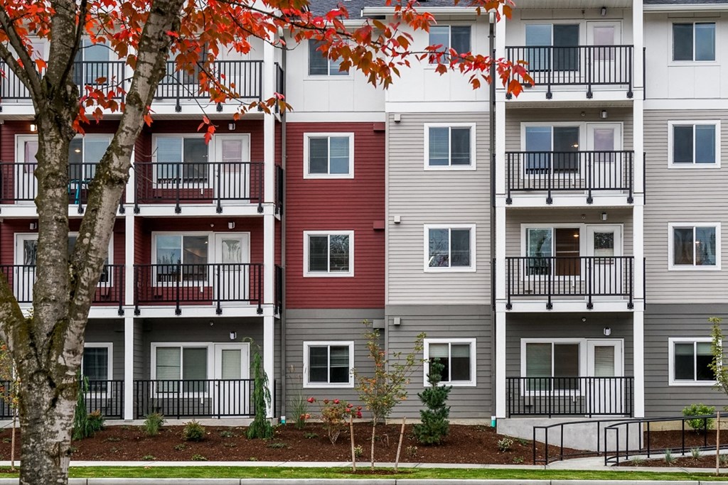 a view of an apartment building with red and gray exterior walls