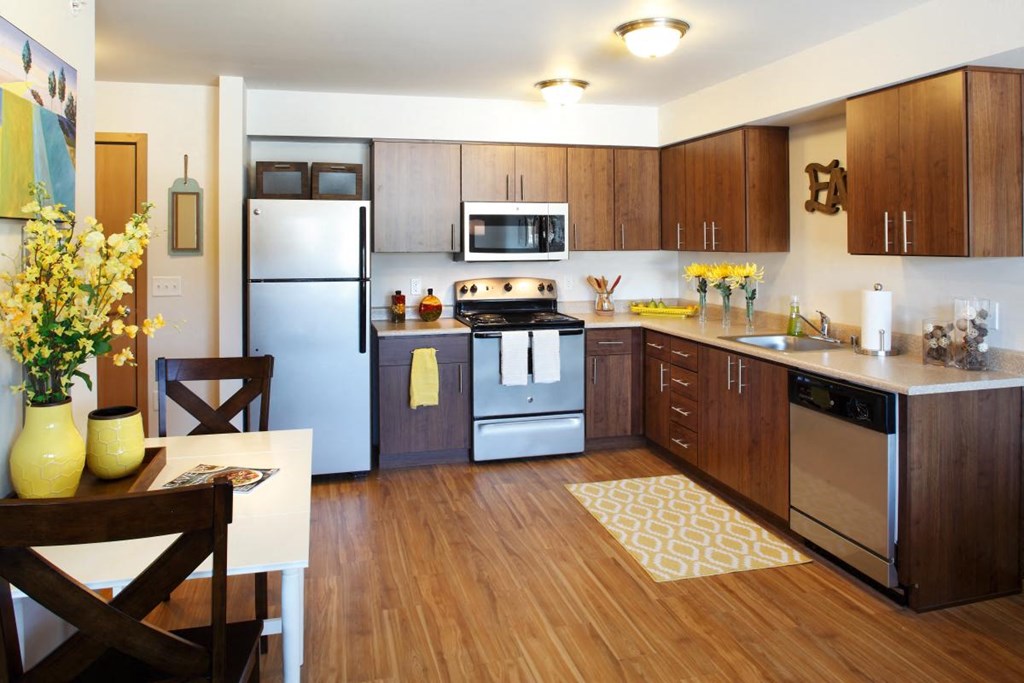 a kitchen with stainless steel appliances and wooden cabinets