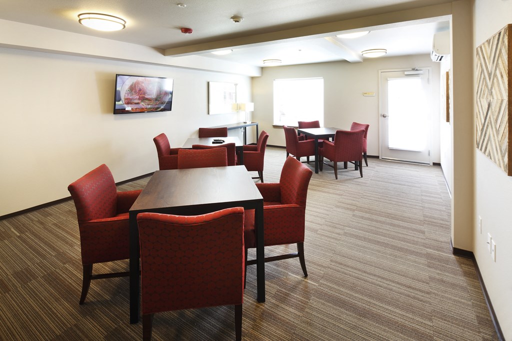 a dining area with tables and chairs in a room