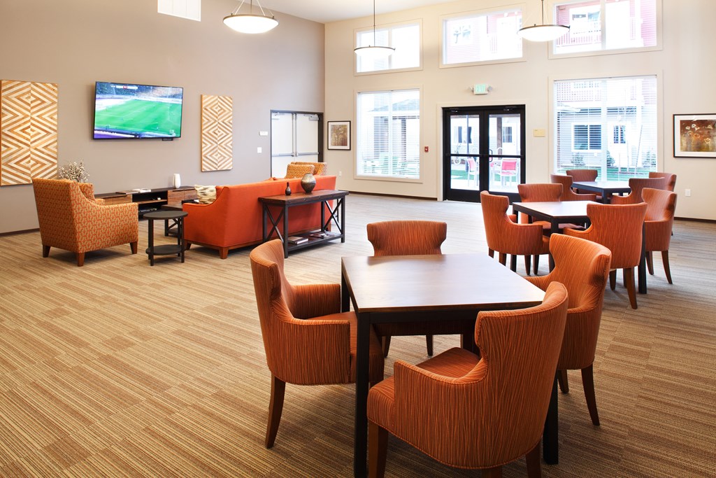 a dining room with tables and chairs and a tv