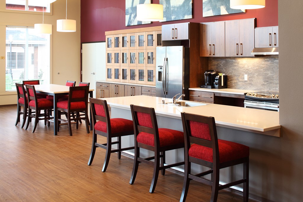 a large kitchen with a dining table and chairs