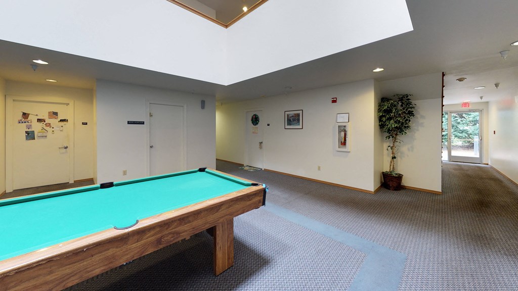 a pool table in a room with white walls