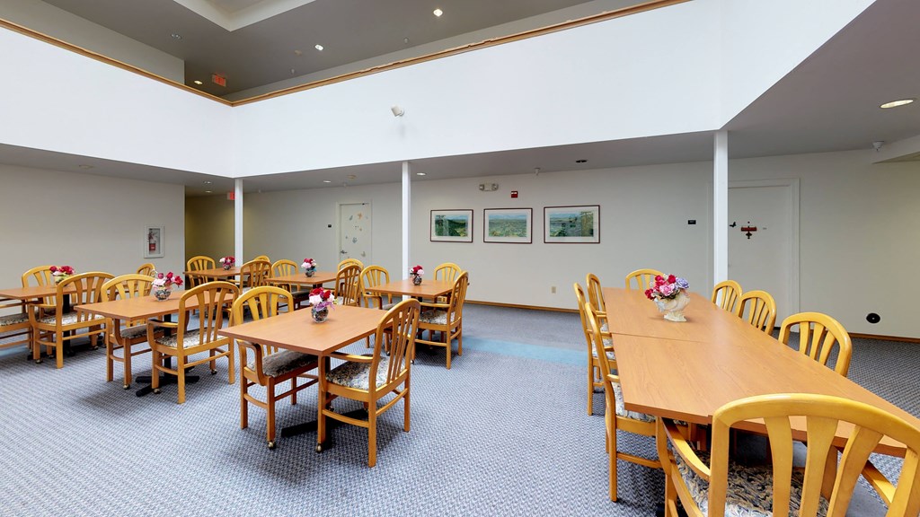 a dining room with tables and chairs in a hall