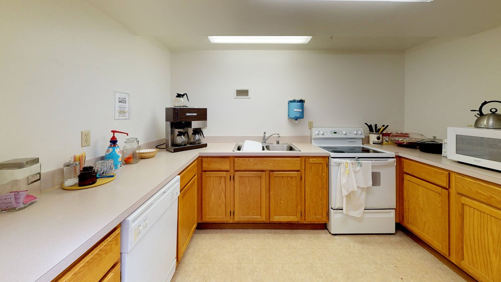 a kitchen with white appliances and wooden cabinets