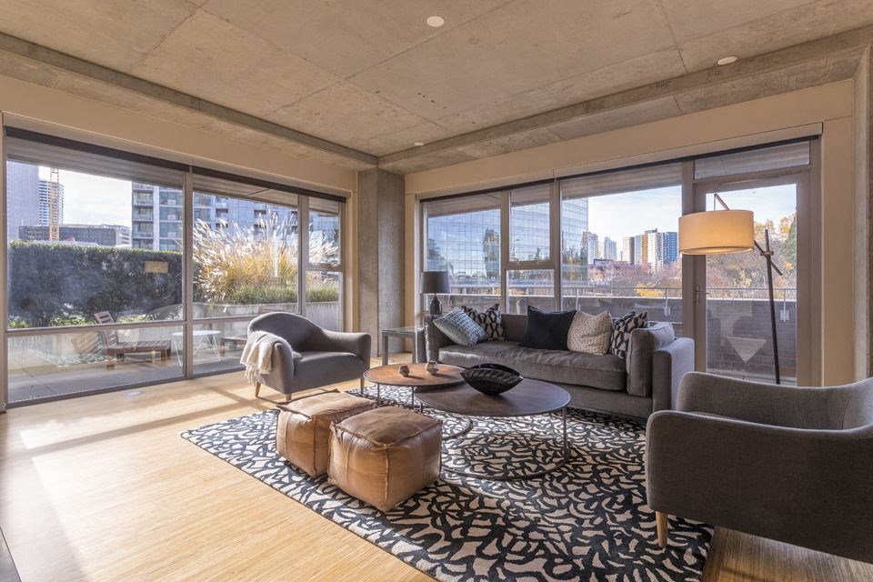 a living room with a couch and chairs and a rug