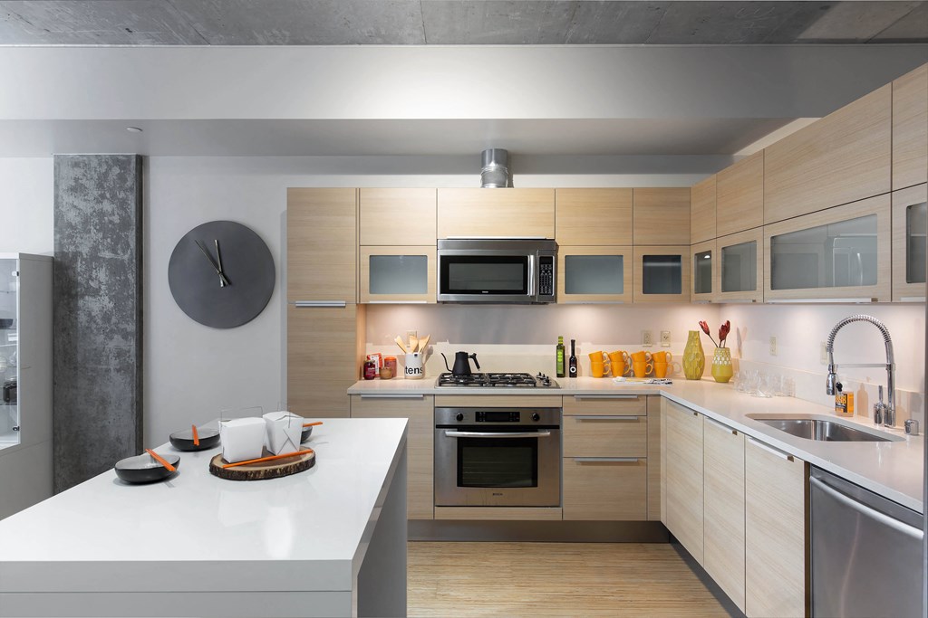 a kitchen with wooden cabinets and stainless steel appliances