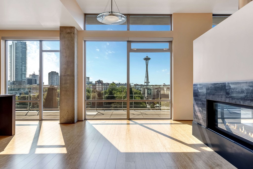 a view of the city from a living room with a fireplace