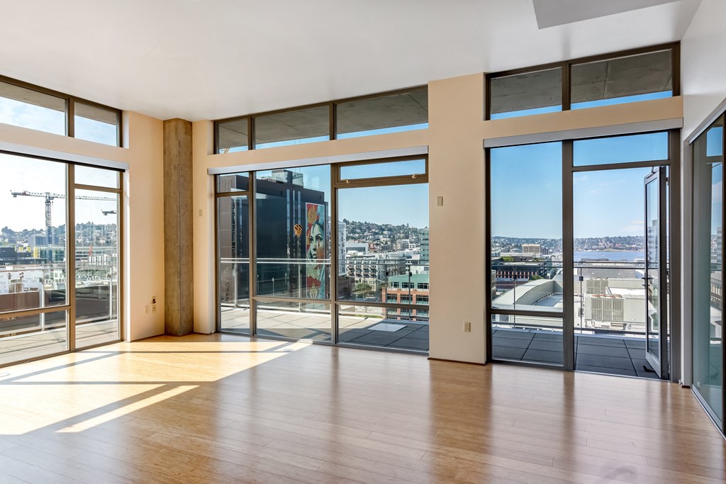 the view of the city from the living room of an apartment