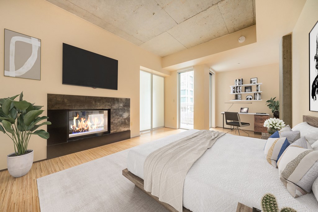 a bedroom with a fireplace and a bed