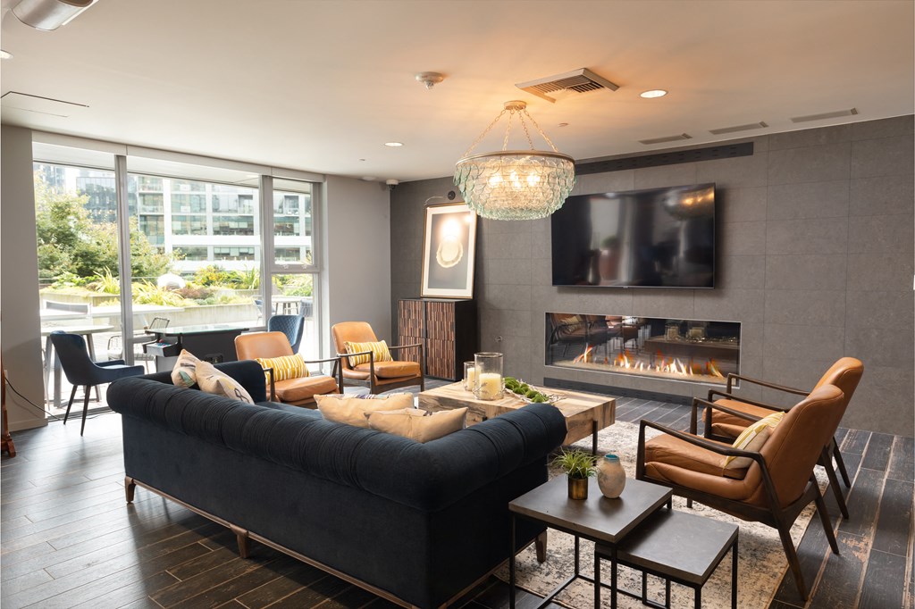 a living room with a black couch and a fireplace