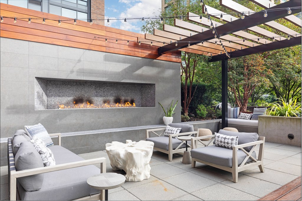 a patio with furniture and a fire pit
