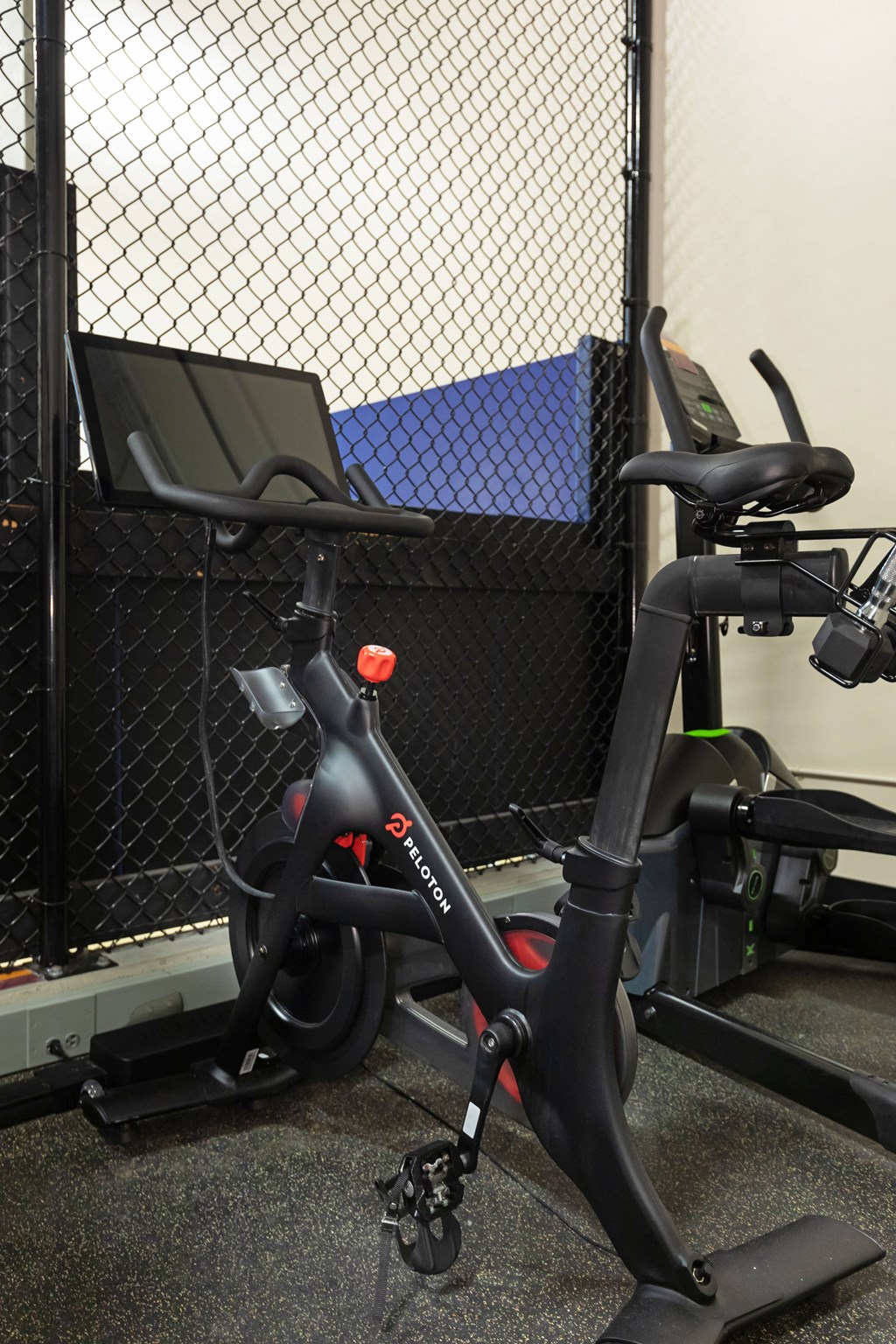 a bike in a gym next to a fence
