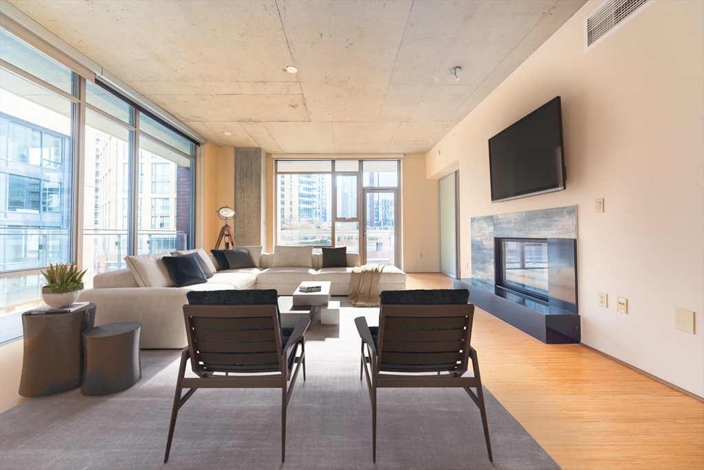 a living room with a couch and chairs and a fireplace