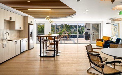 A modern kitchen with a dining table and chairs.