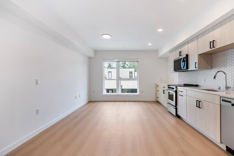 A kitchen with wooden floors and white walls.