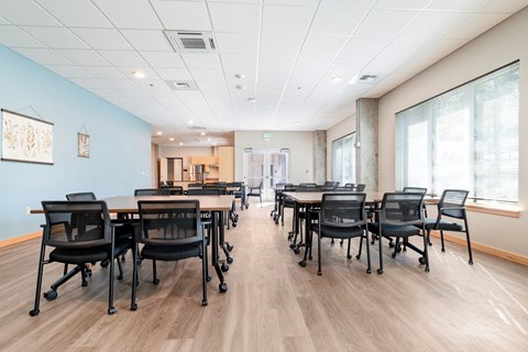 A conference room with a long table and chairs.