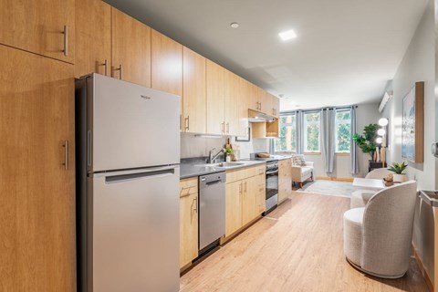 A modern kitchen with wooden cabinets and stainless steel appliances.