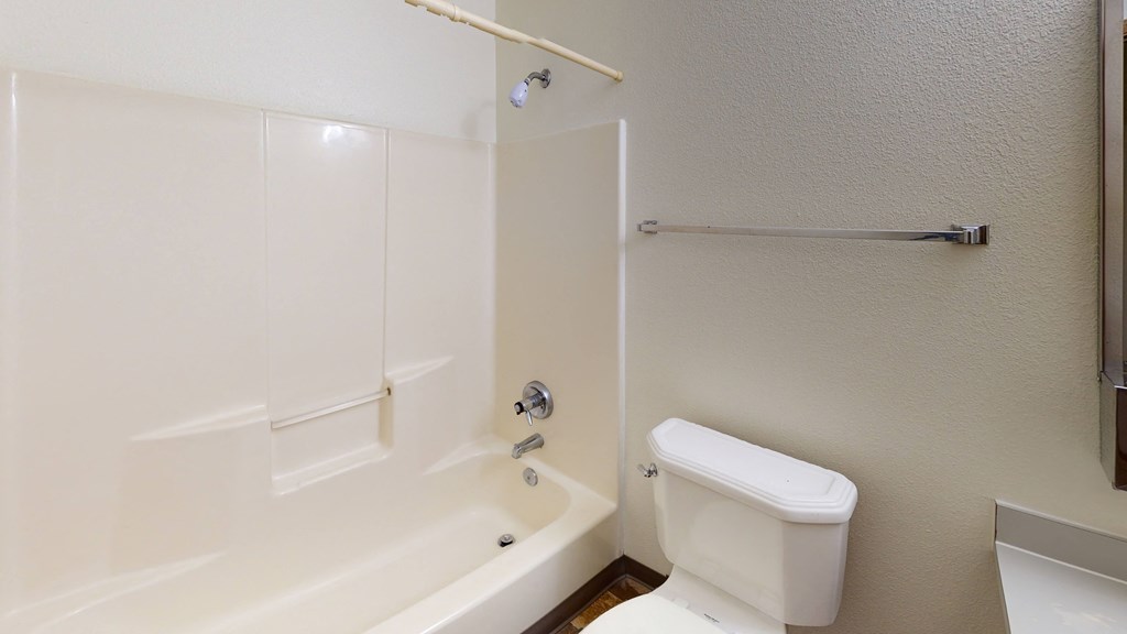 a bathroom with a tub and a toilet and a sink