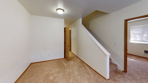 an upstairs room with a door to a closet and a window