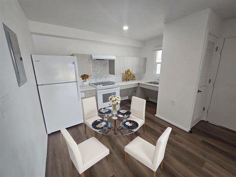 A kitchen with a table and chairs in the middle.