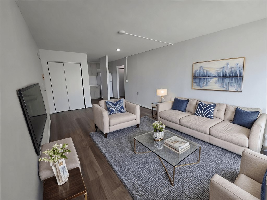 A living room with a couch, chairs, and a coffee table.