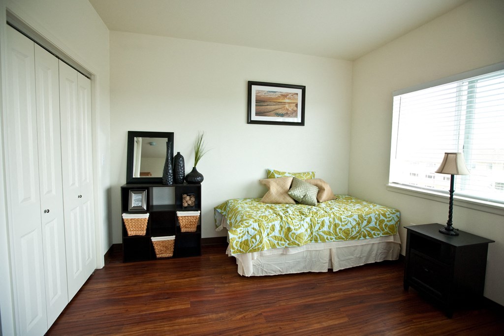 a bedroom with a bed and a window