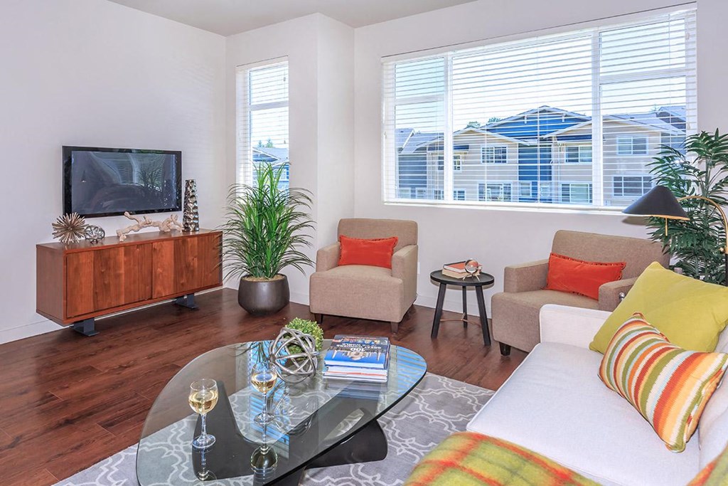 a living room with a couch and a coffee table and a television