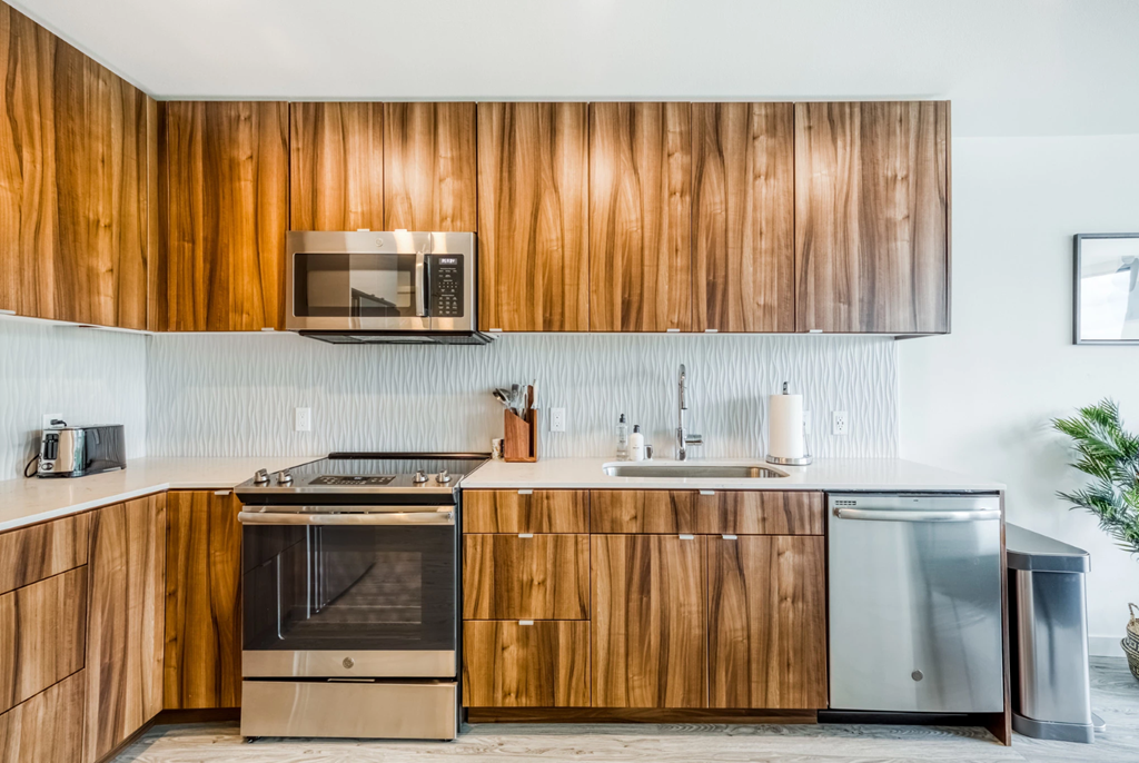 a kitchen with wooden cabinets and stainless steel appliances