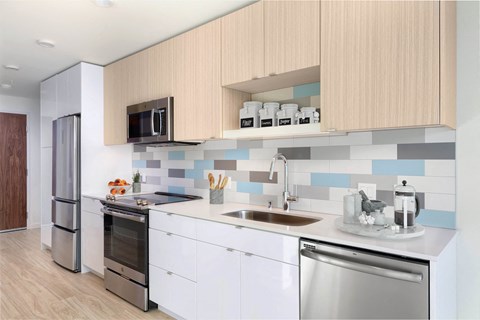 a kitchen with white cabinets and a sink and a refrigerator