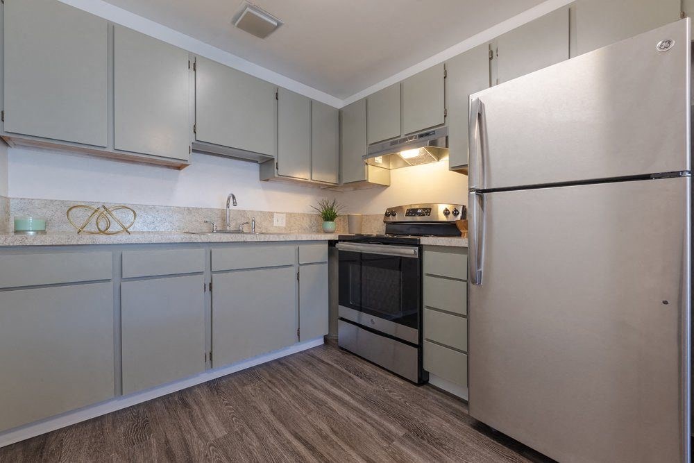 a kitchen with white cabinets and stainless steel appliances