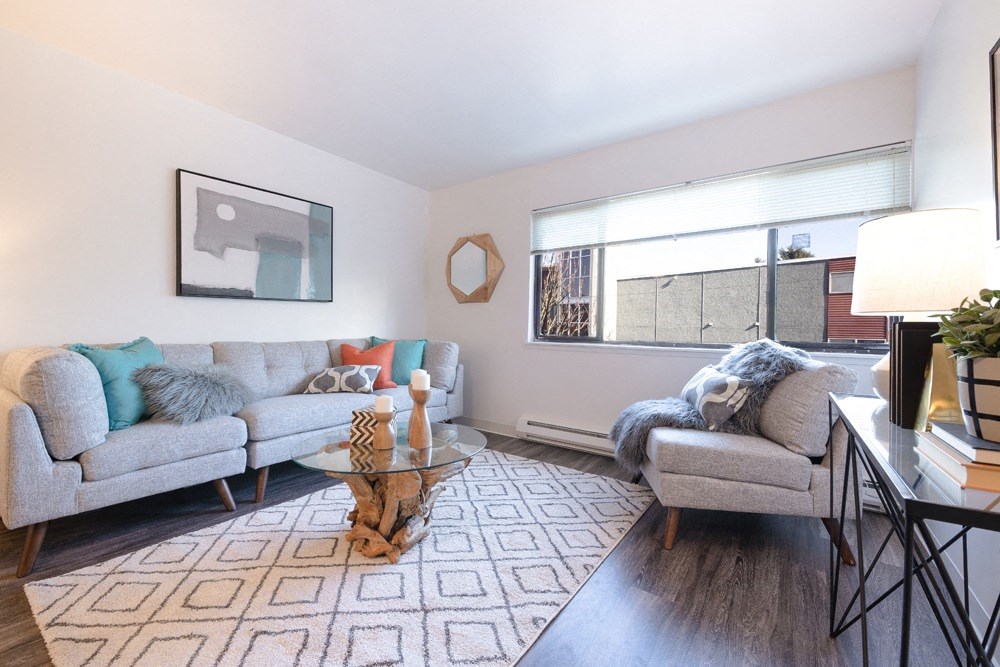 a living room with two couches and a glass coffee table