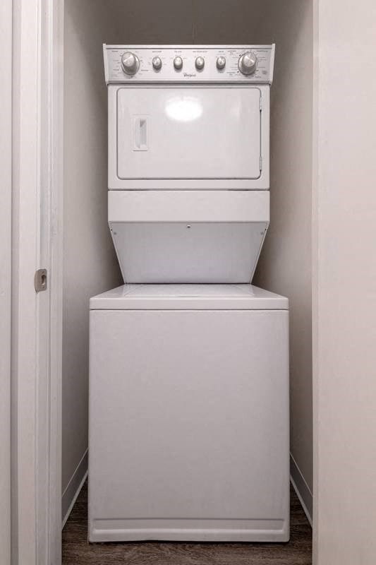 a white washer and dryer in a small room