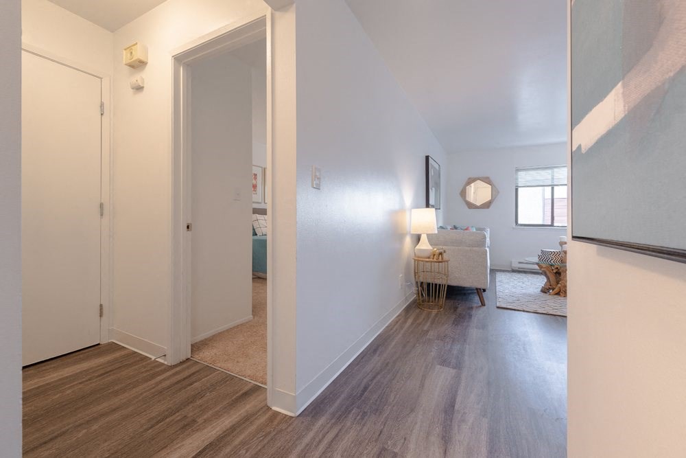 a living room and hallway with a door to a bedroom