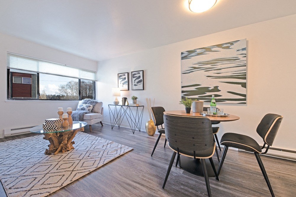 an open living room and dining room with a table and chairs