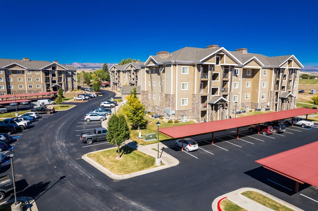 A parking lot in front of apartment buildings.
